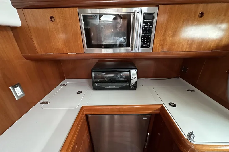 Slide: The Image of Galley kitchen in 2003 Beneteau 57 yacht with microwave and toaster oven. - 30