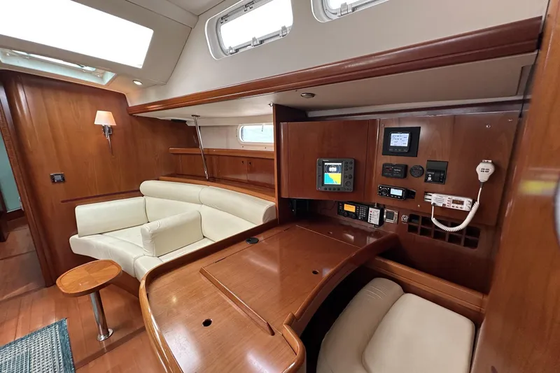 Slide: The Image of Luxurious interior of 2003 Beneteau 57 yacht with navigation station and seating area. - 32