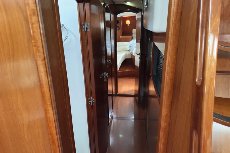 Slide: The Image of Luxurious wooden interior of a 2003 Beneteau 57 yacht cabin hallway. - 34