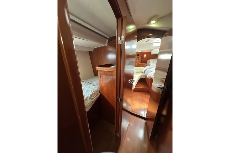 Slide: The Image of Interior of 2003 Beneteau 57 yacht, featuring cozy wooden cabin and sleeping quarters. - 37