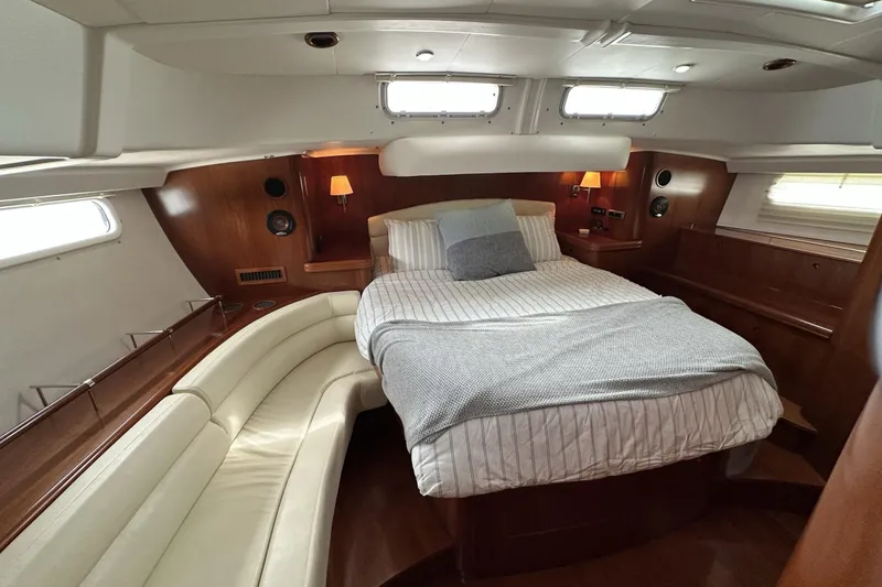 Slide: The Image of Luxurious cabin interior of a 2003 Beneteau 57 yacht with cozy bed and seating. - 38