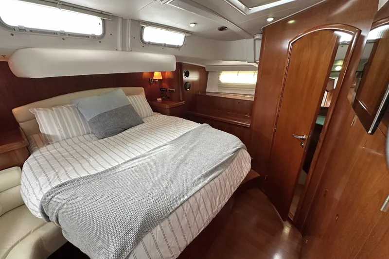 Slide: The Image of Luxurious cabin interior of a 2003 Beneteau 57 yacht with cozy bedding. - 39