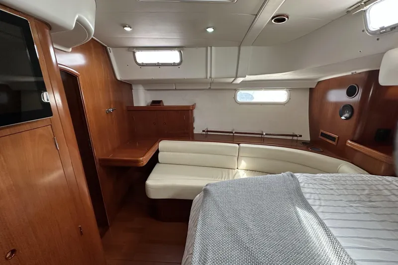 Slide: The Image of Luxurious interior of a 2003 Beneteau 57 yacht with wood finishes and cozy seating. - 40