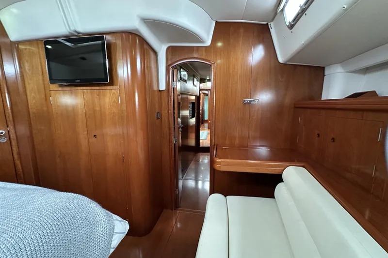 Slide: The Image of Luxurious interior of a 2003 Beneteau 57 yacht with wood paneling and seating. - 48