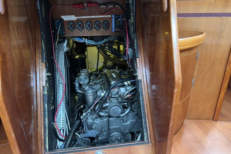 Slide: The Image of Engine compartment of a 2003 Beneteau 57 sailboat, showcasing intricate wiring and components. - 49