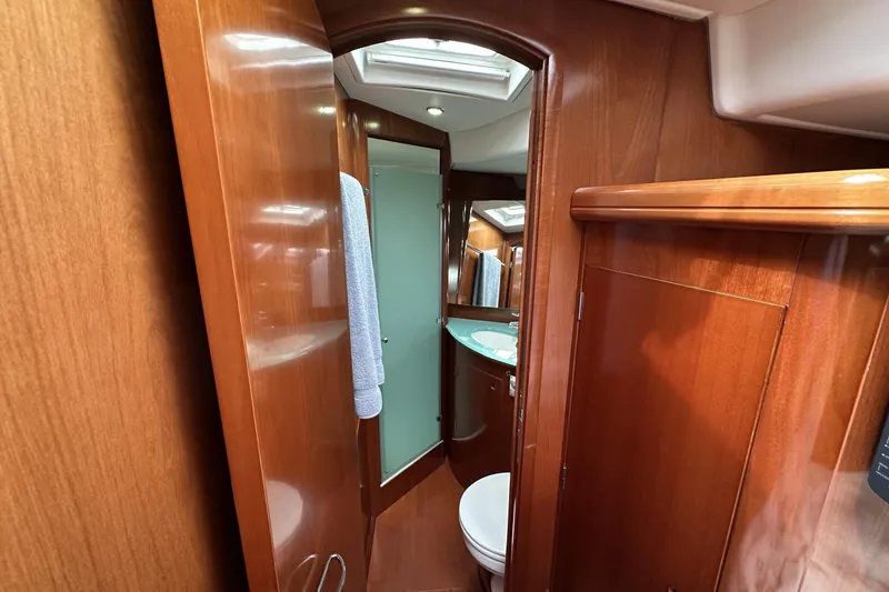 Slide: The Image of Luxurious wooden interior of 2003 Beneteau 57 yacht bathroom with modern fixtures. - 5