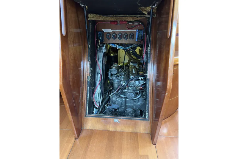 Slide: The Image of Engine compartment of a 2003 Beneteau 57 sailboat, showcasing mechanical components and wiring. - 50
