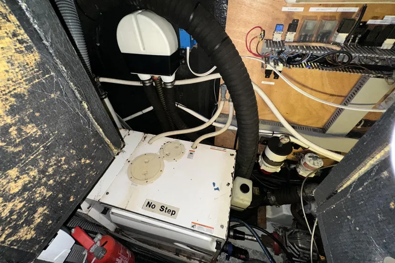 Slide: The Image of Engine room of a 2003 Beneteau 57 yacht with visible machinery and wiring. - 52