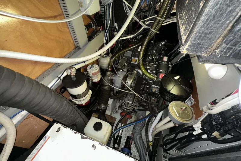Slide: The Image of Engine room of a 2003 Beneteau 57 yacht, showcasing complex wiring and components. - 53