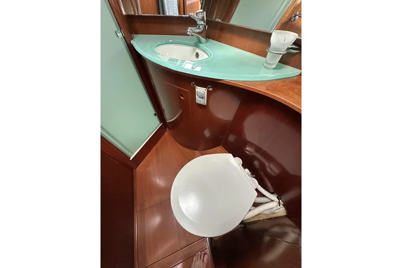 Slide: The Image of Luxurious bathroom in a 2003 Beneteau 57 yacht with modern sink and wooden finish. - 6