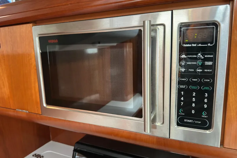 Slide: The Image of Stainless steel microwave oven in a 2003 Beneteau 57 yacht kitchen. - 63