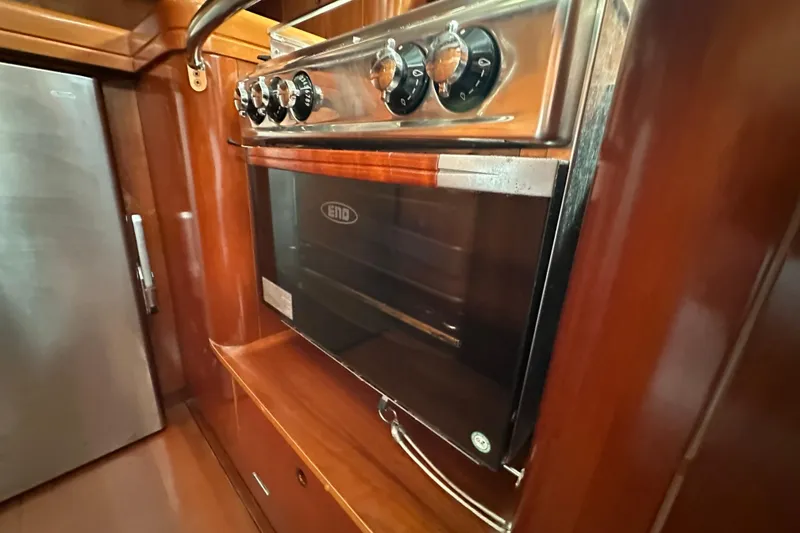 Slide: The Image of Galley oven in 2003 Beneteau 57 yacht, featuring stainless steel finish. - 65
