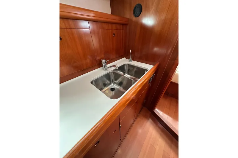 Slide: The Image of Luxurious wooden galley with double sink on 2003 Beneteau 57 yacht. - 66