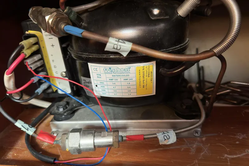 Slide: The Image of Marine refrigeration unit in a 2003 Beneteau 57 yacht, featuring wiring and labels. - 68