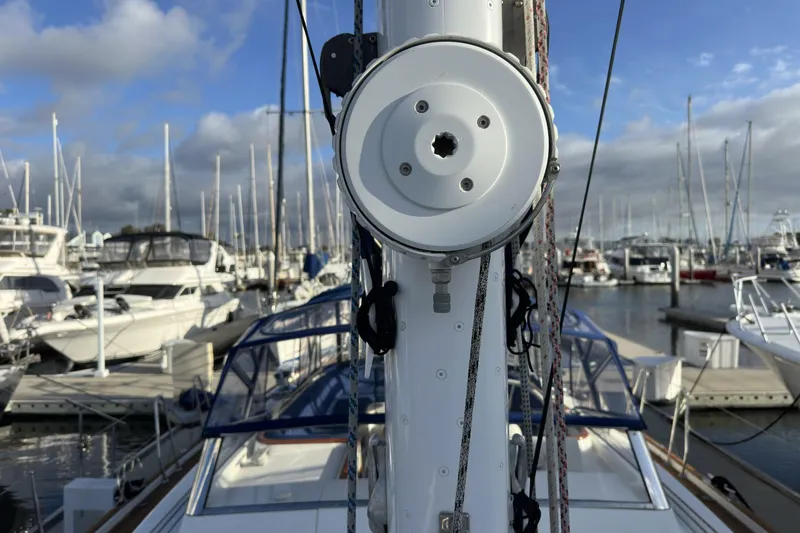 Slide: The Image of 2003 Beneteau 57 sailboat mast and rigging in a marina setting. - 69