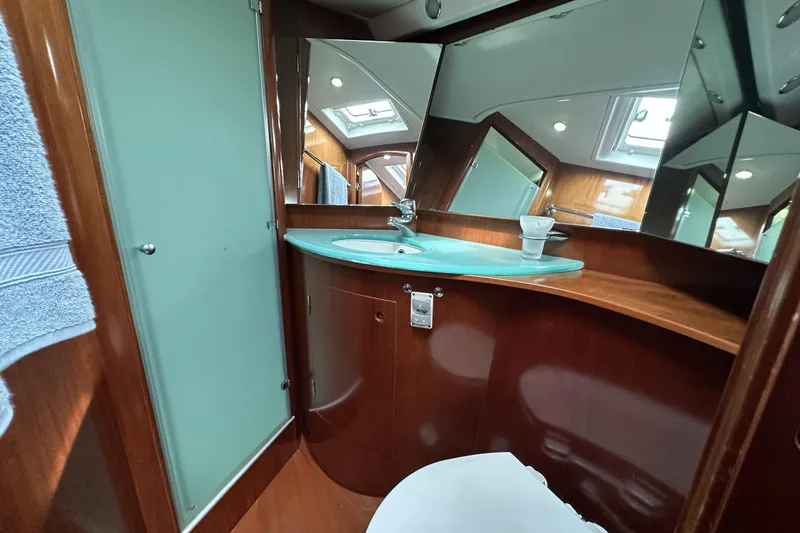 Slide: The Image of Luxurious bathroom interior of 2003 Beneteau 57 yacht with modern fixtures and wood finish. - 7