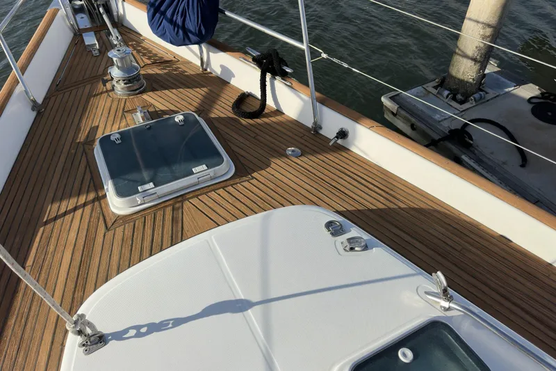 Slide: The Image of Deck of 2003 Beneteau 57 sailboat with wooden finish and hatches. - 70