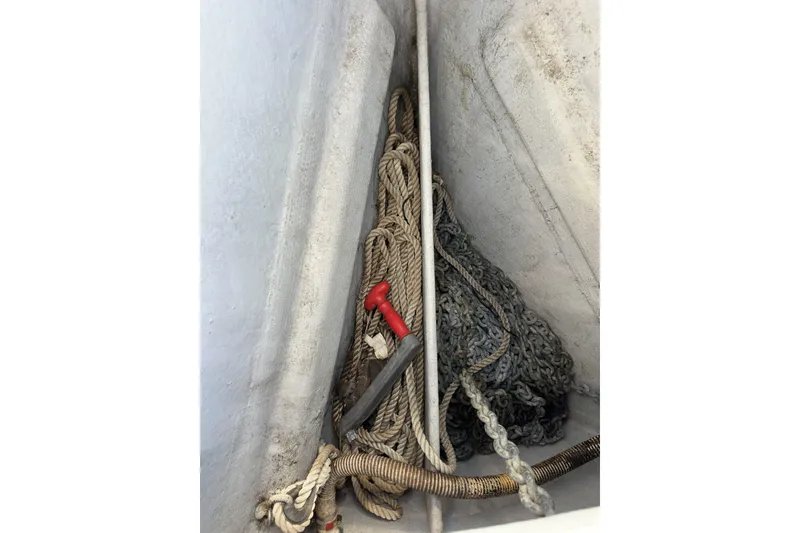 Slide: The Image of Anchor locker of a 2003 Beneteau 57 sailboat with ropes and chains. - 74