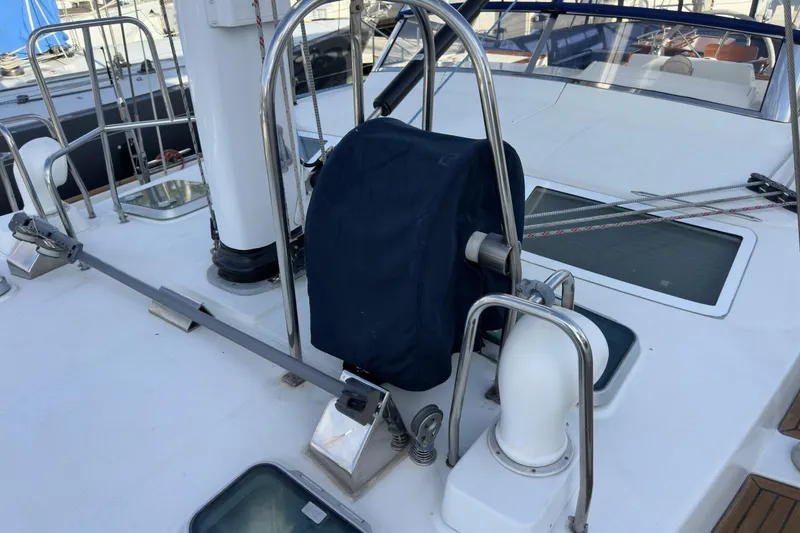 Slide: The Image of Deck of 2003 Beneteau 57 yacht with covered equipment and railing. - 76