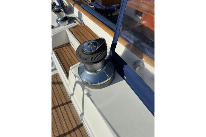 Slide: The Image of Winch on deck of 2003 Beneteau 57 sailboat, featuring teak flooring and blue trim. - 78