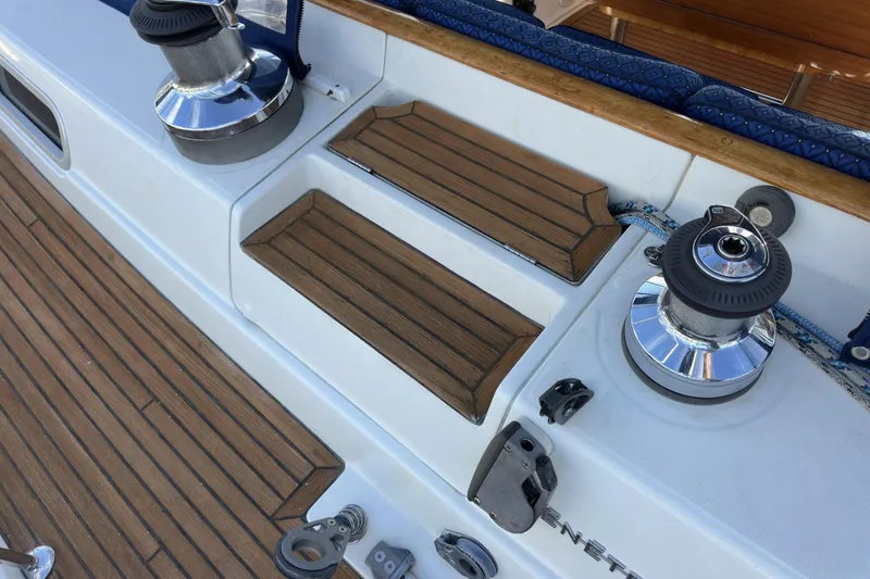 Slide: The Image of Deck of 2003 Beneteau 57 sailboat with winches and teak steps. - 83