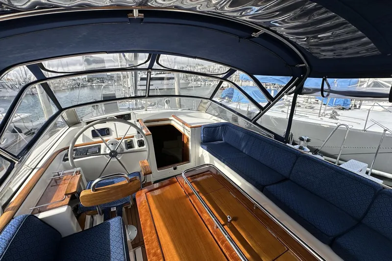 Slide: The Image of Cockpit of 2003 Beneteau 57 yacht with blue seating and wooden accents. - 88