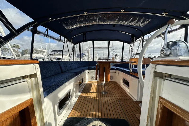 Slide: The Image of Interior view of a 2003 Beneteau 57 yacht with blue seating and wooden flooring. - 89