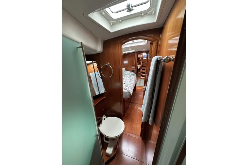 Slide: The Image of Luxurious interior of 2003 Beneteau 57 yacht, featuring a cozy cabin and elegant wood finishes. - 9