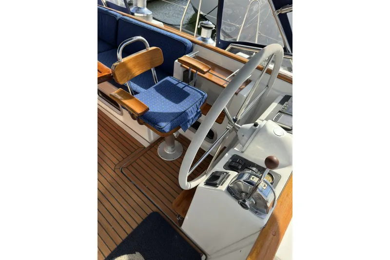 Slide: The Image of Cockpit of 2003 Beneteau 57 sailboat with wooden accents and steering wheel. - 91