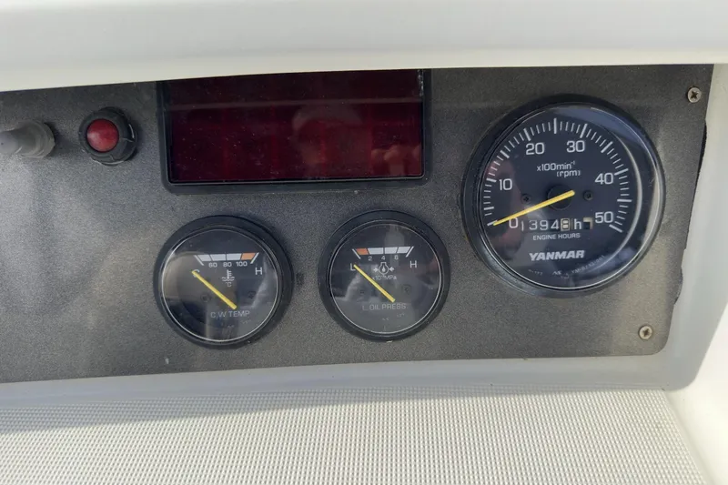 Slide: The Image of Dashboard gauges of a 2003 Beneteau 57 yacht, showing engine hours and temperature. - 93