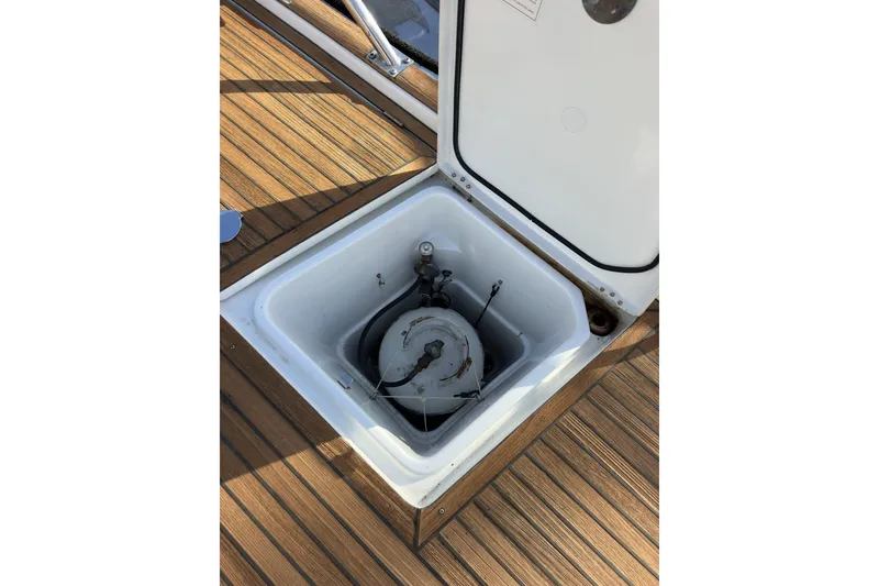 Slide: The Image of Open hatch on 2003 Beneteau 57 yacht deck, revealing storage compartment. - 96