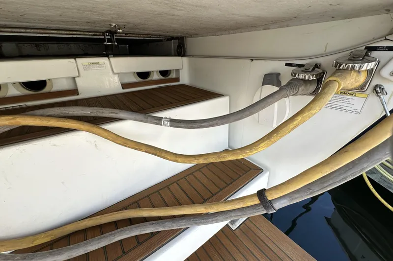 Slide: The Image of Beneteau 57 yacht stern with power cables and teak steps, 2003 model. - 98