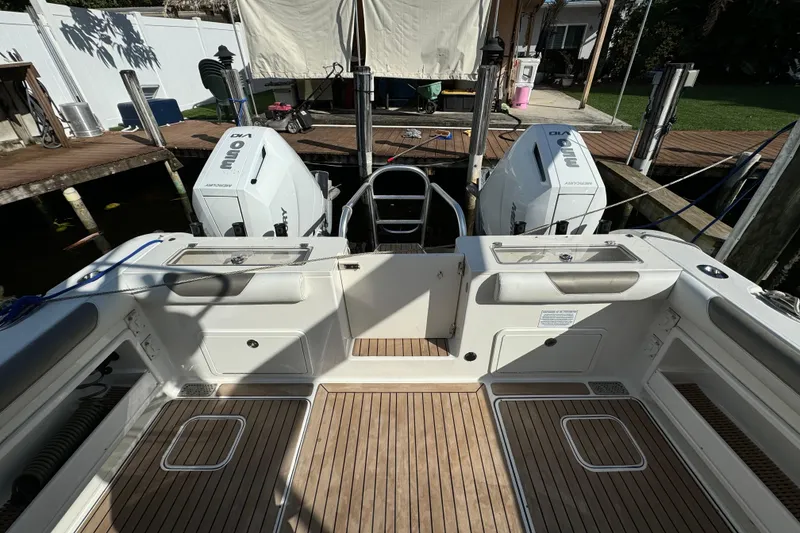 Slide: The Image of 2023 World Cat 325 CC boat with twin engines, docked at a marina. - 13