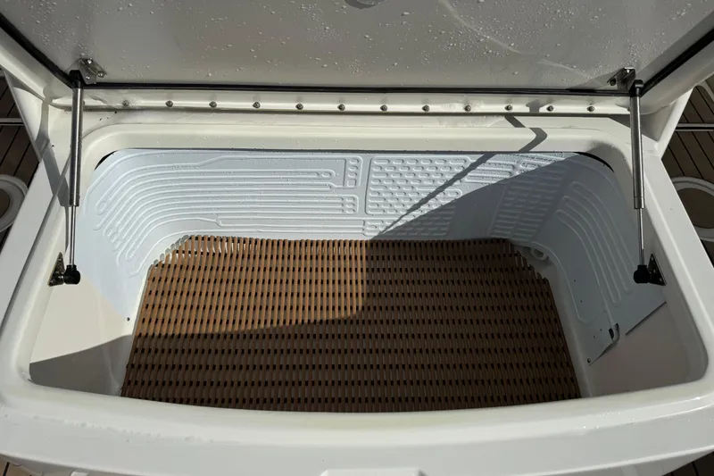 Slide: The Image of Open storage compartment on 2023 World Cat 325 CC boat, featuring a textured interior. - 17