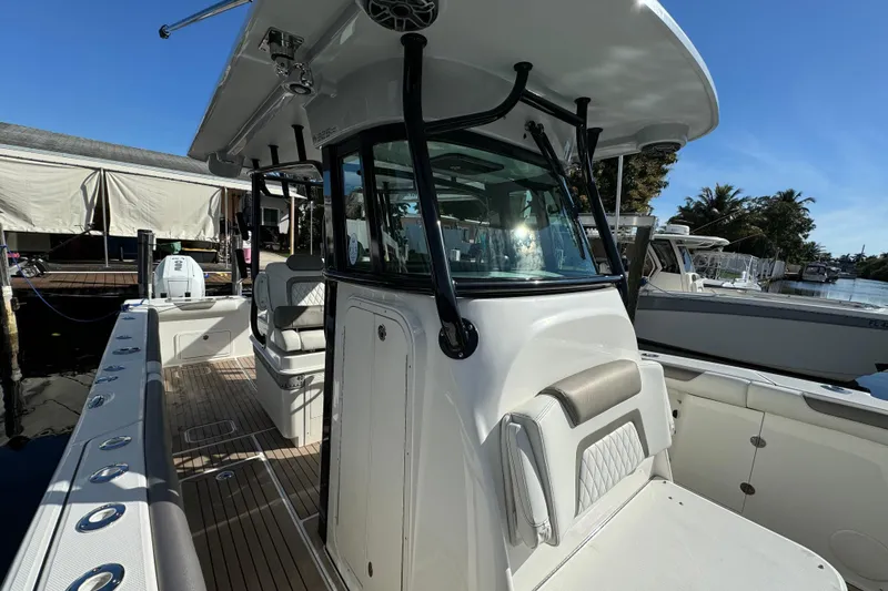 Slide: The Image of 2023 World Cat 325 CC boat docked, showcasing sleek design and spacious seating. - 19