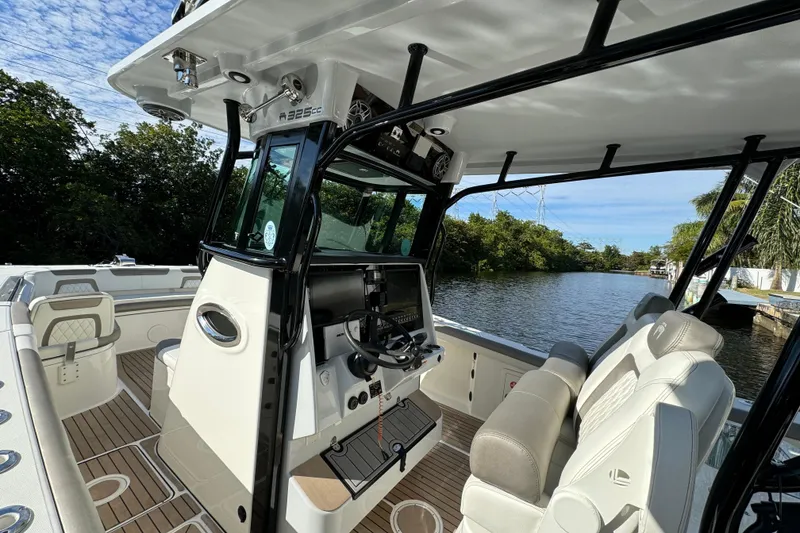 Slide: The Image of 2023 World Cat 325 CC boat interior with helm, seats, and waterway view. - 23