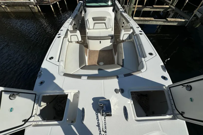 Slide: The Image of 2023 World Cat 325 CC boat interior with open storage compartments and seating. - 28