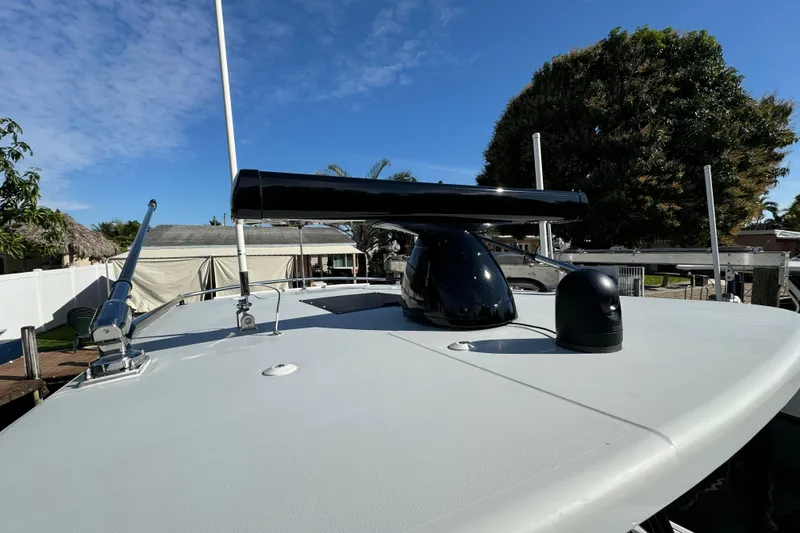 Slide: The Image of 2023 World Cat 325 CC boat deck with radar and antennas under clear sky. - 30