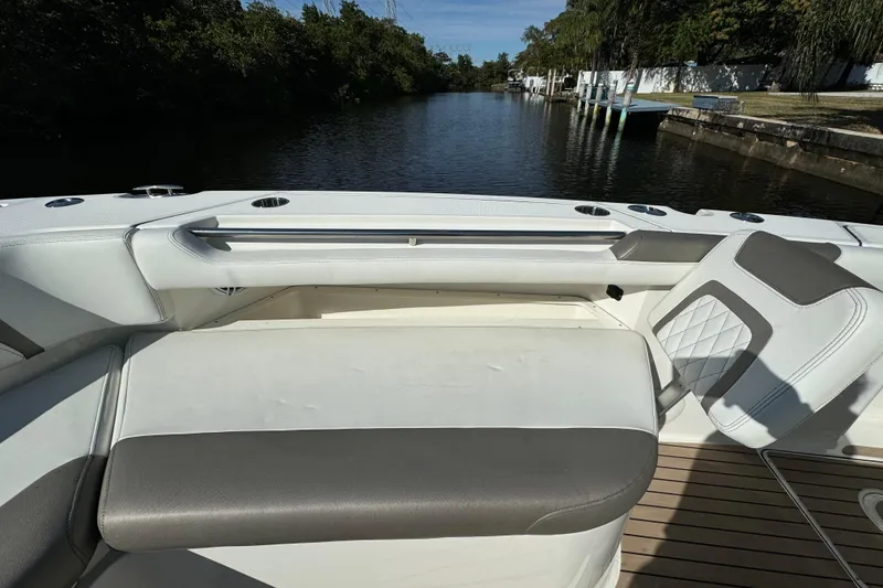 Slide: The Image of 2023 World Cat 325 CC boat interior with cushioned seating and scenic waterway view. - 33