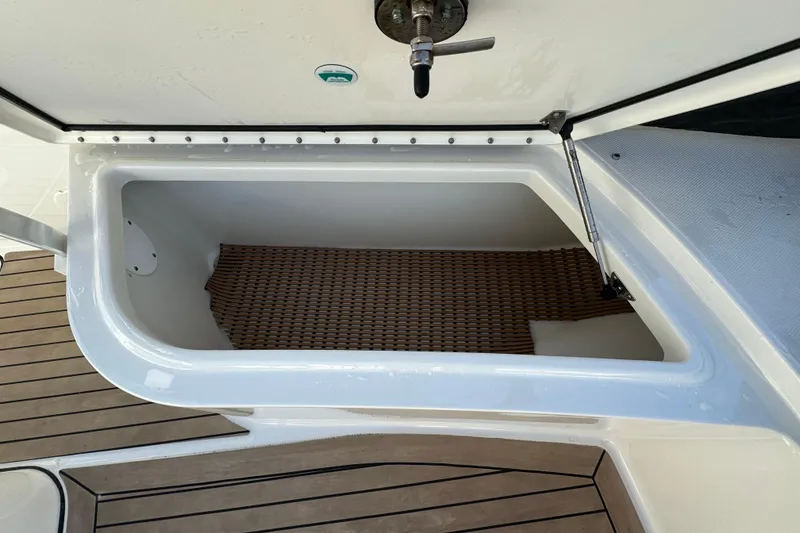 Slide: The Image of Storage compartment on 2023 World Cat 325 CC boat with teak flooring. - 34