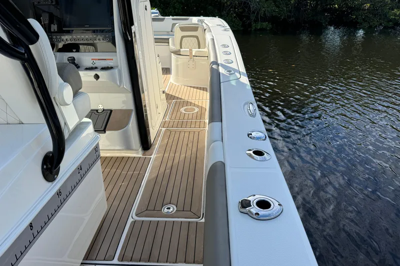 Slide: The Image of 2023 World Cat 325 CC boat interior with seating and control panel by the water. - 35