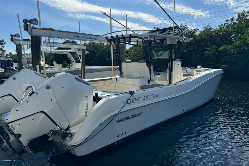 Slide: The Image of 2023 World Cat 325 CC boat docked, featuring dual Mercury engines. - 38