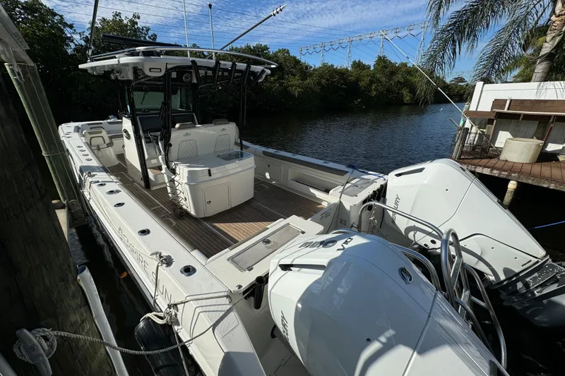 Slide: The Image of 2023 World Cat 325 CC boat docked by a scenic river with lush greenery. - 39