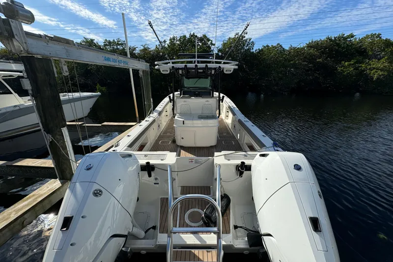 Slide: The Image of 2023 World Cat 325 CC boat docked, featuring dual outboard engines and spacious deck. - 40