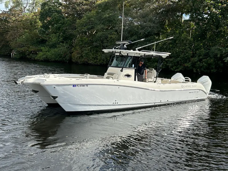 Slide: The Image of 2023 World Cat 325 CC boat cruising on a calm river. - 5