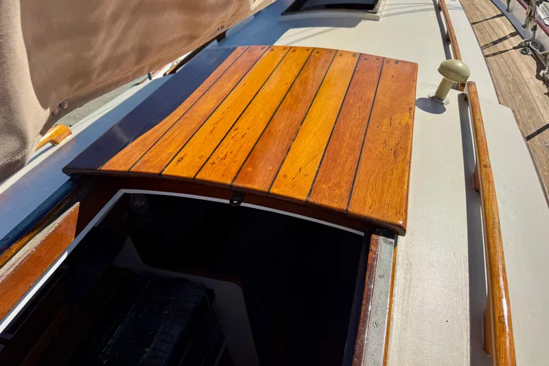 Slide: The Image of Wooden hatch on a 1946 Phillip Rhodes 42 sailboat deck, showcasing classic craftsmanship. - 14