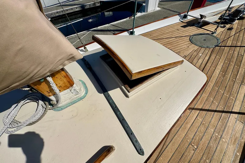 Slide: The Image of Wooden deck of a 1946 Phillip Rhodes 42 sailboat with open hatch and rope. - 15