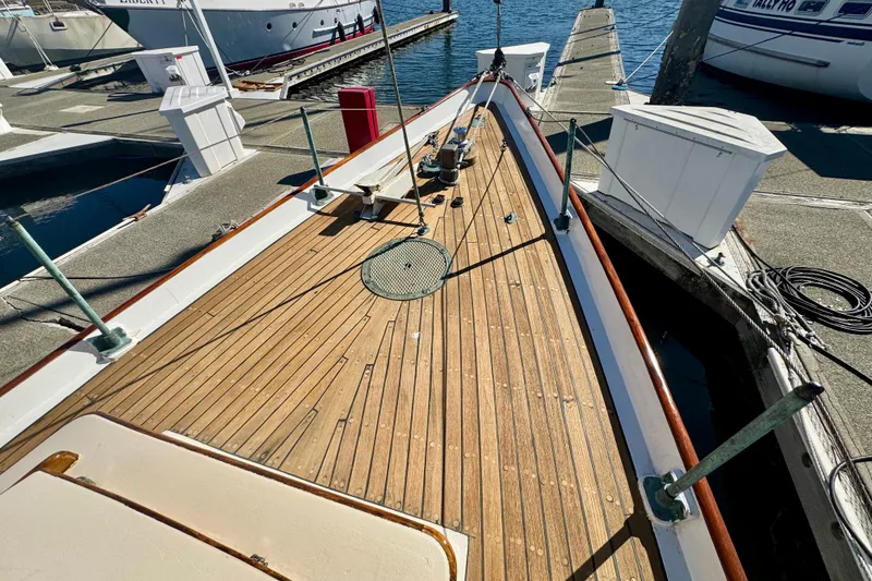 Slide: The Image of Wooden deck of a 1946 Phillip Rhodes 42 sailboat docked at a marina. - 17