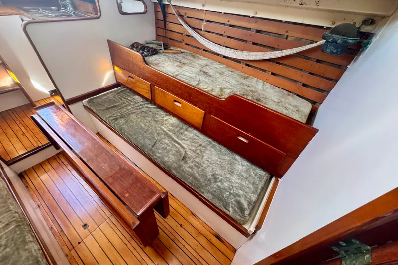 Slide: The Image of Vintage 1946 Phillip Rhodes 42 sailboat interior with wooden benches and storage. - 21