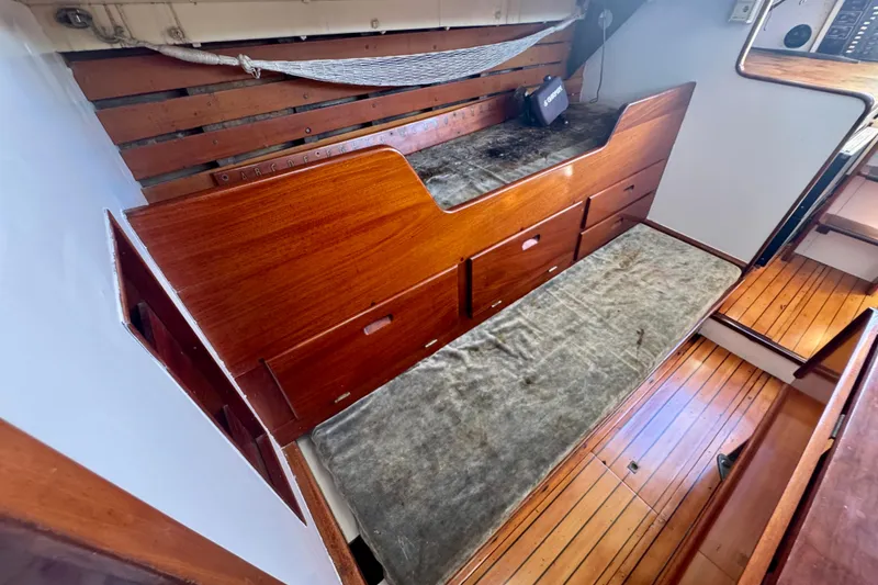 Slide: The Image of Vintage 1946 Phillip Rhodes 42 sailboat interior with wooden cabinetry and seating area. - 22